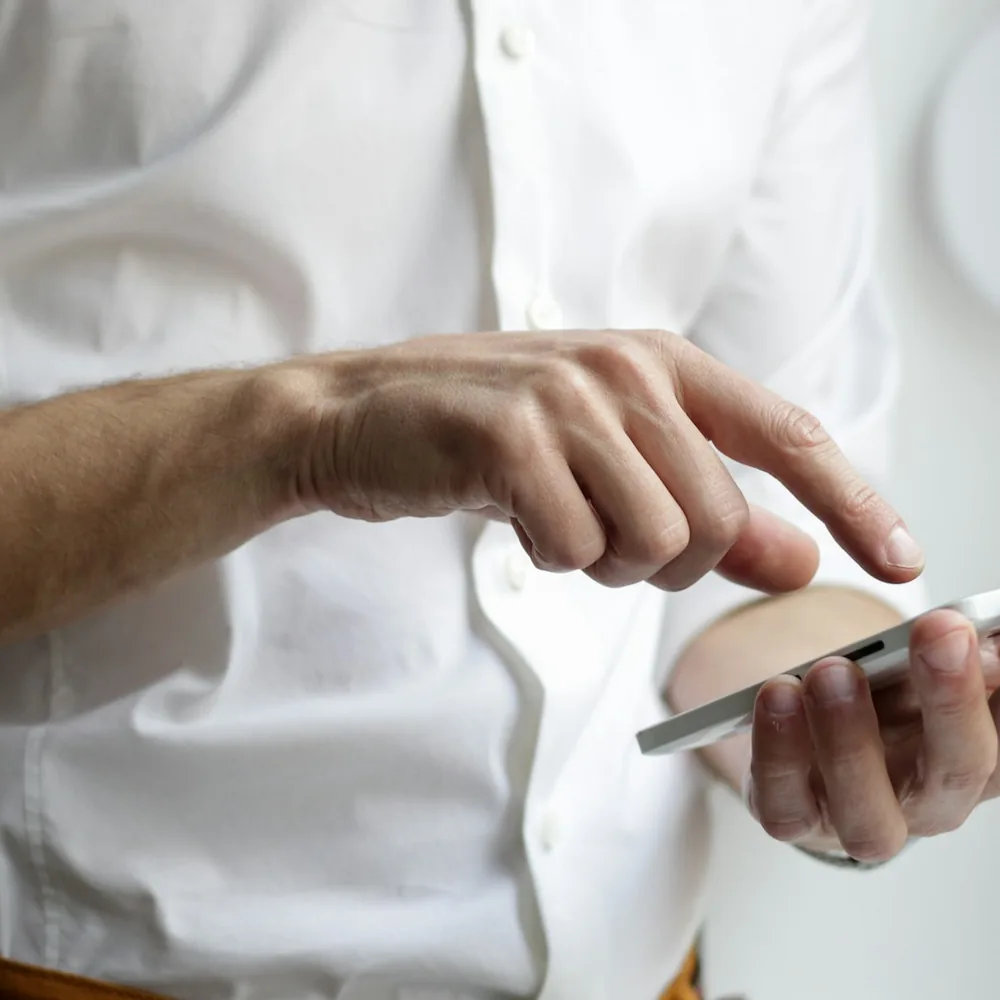 Traveller using a phone at a café table